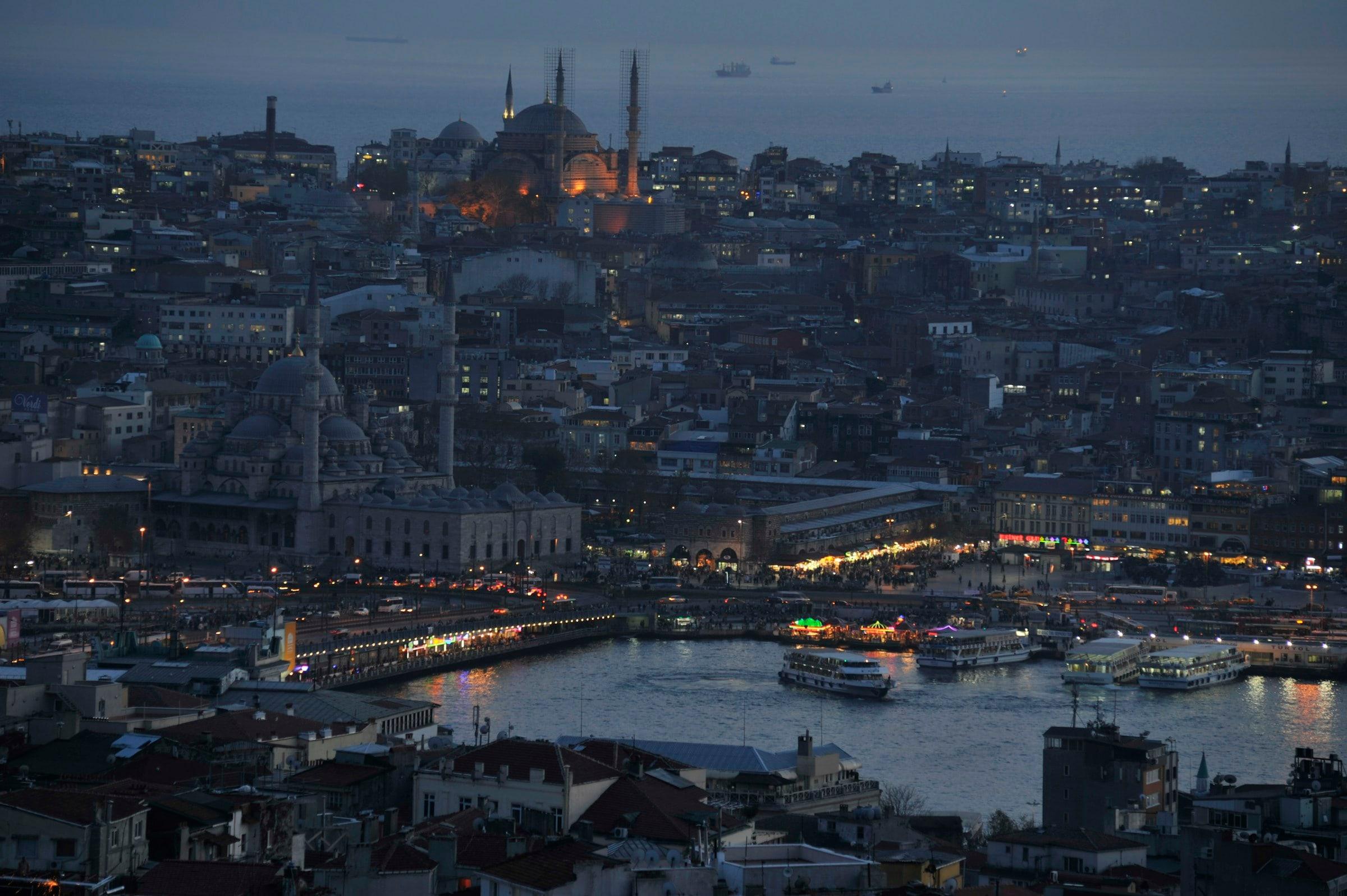 The Golden Horn at dusk - ferries at Eminönü and the lit Galata Bridge