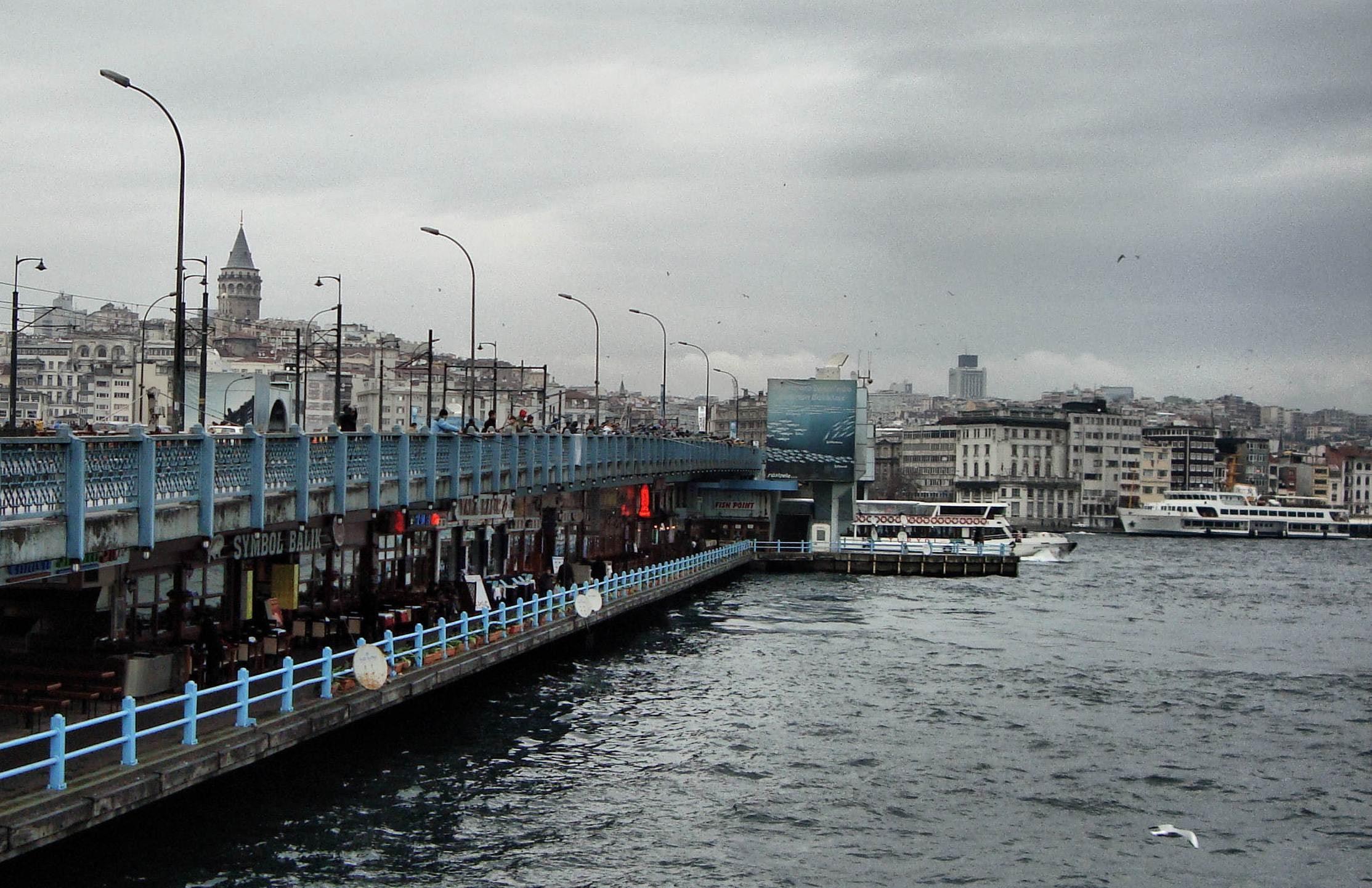 Galata Bridge with anglers along the rail and Galata Tower behind it