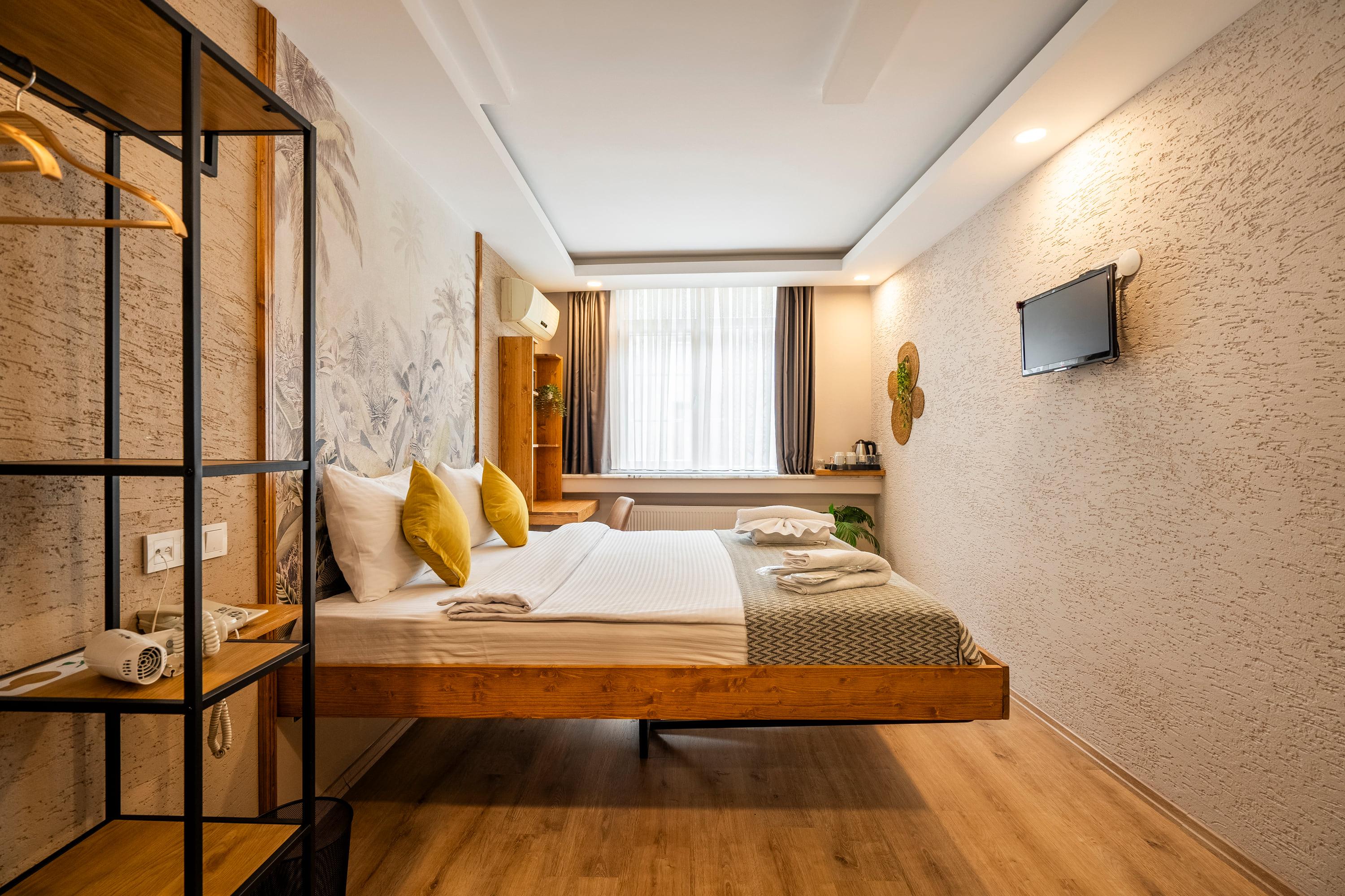The oak-floored room with its timber bed and plastered wall