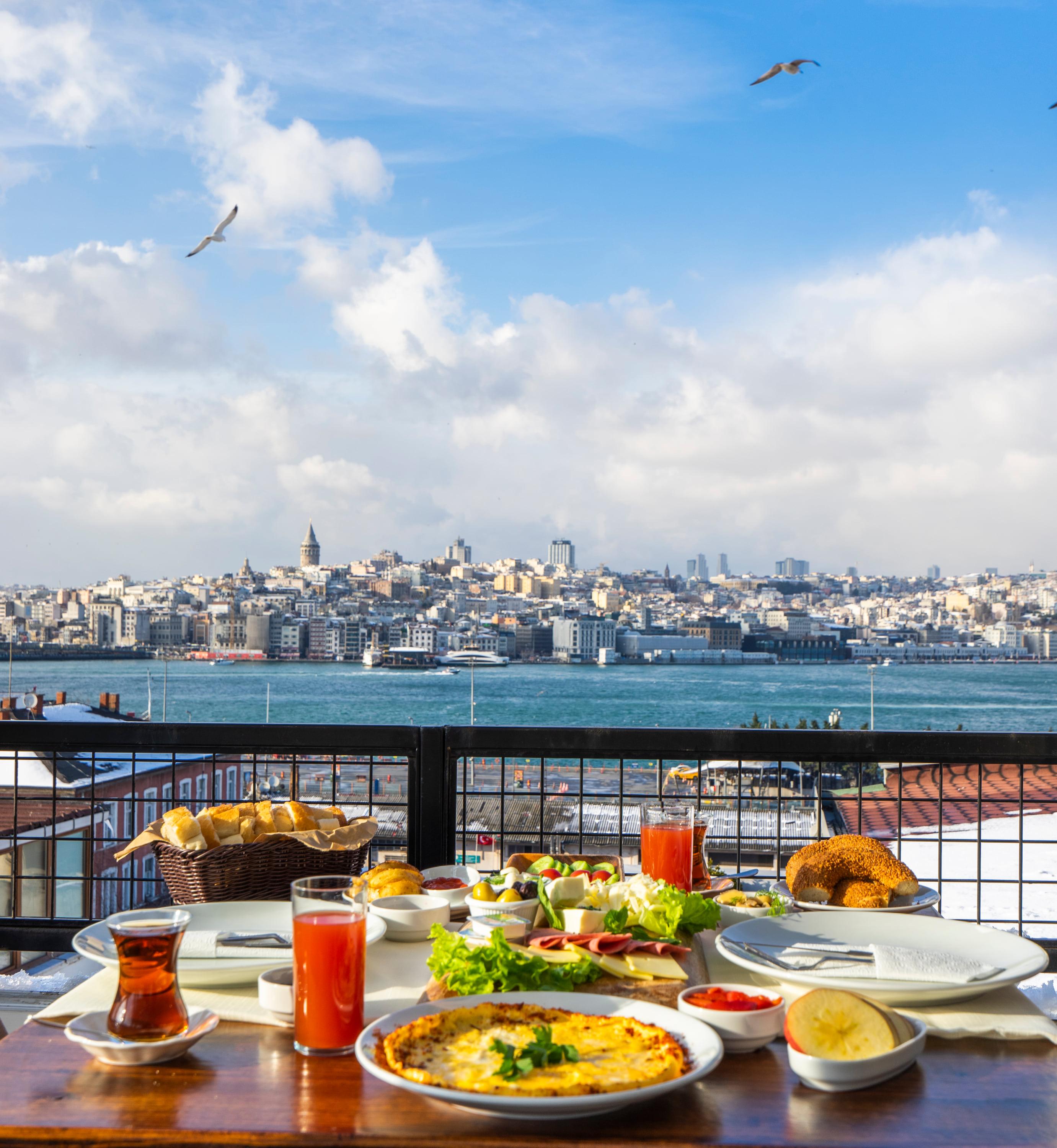A table on the terrace, the Golden Horn and Galata Tower behind